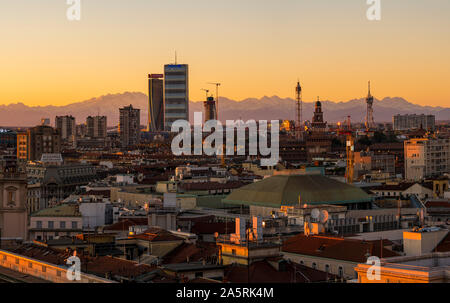 Milan, Italy: City skyline at sunset. Panoramic view of Milano city with the new skyscrapers in CityLife district. Italian Alps in the background. Stock Photo