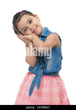 Young Little Sweet Girl Enjoying A Happy Daydream Isolated on White Background Stock Photo