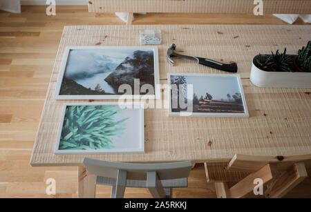 hanging frames and pictures laid out ready to be hung up on a wall Stock Photo