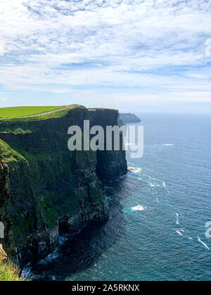 View atop the famous Cliffs of Moher overlooking the atlantic ocean Stock Photo