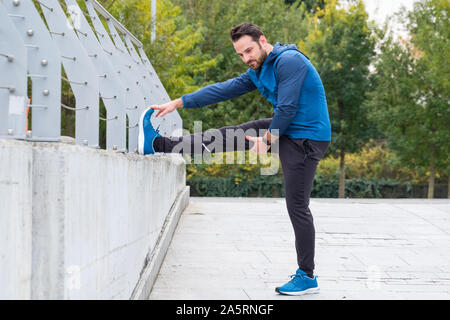 Warming up with some stretches. Athletic man stretching isolated on white.  Muscle stretching. Stretching workout routine. Stretching exercises for  better flexibility. Preventing injury Stock Photo - Alamy