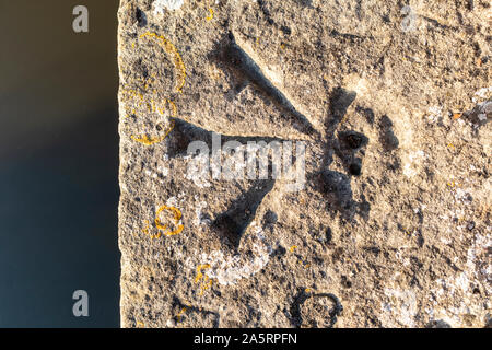 An Ordnance Survey trig point on the parapet of Tadpole Bridge near Bampton, Oxfordshire UK Stock Photo