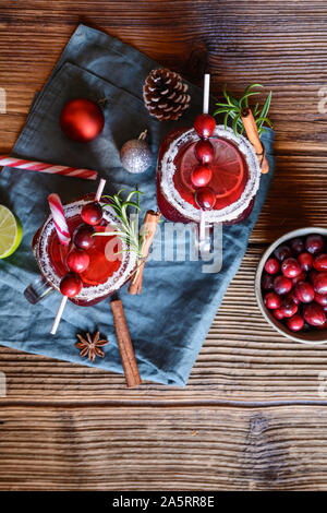 Christmas drink, hot mulled wine with cranberries, lime, star anise and cinnamon on wooden background Stock Photo