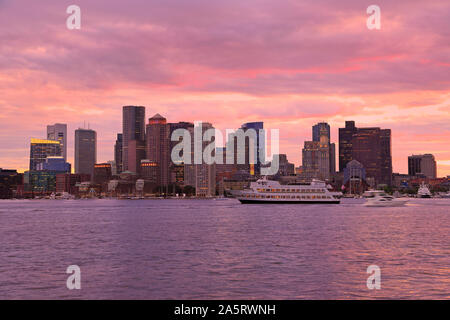 Boston skyline at sunset wit cruise boat sailing on the foreground, USA Stock Photo