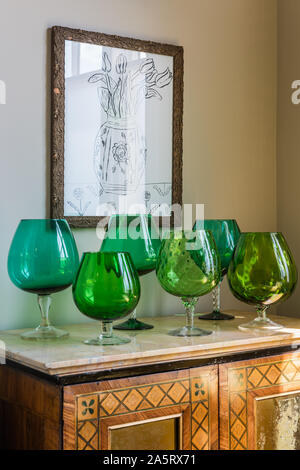 Vintage green glassware in antique sideboard. Stock Photo