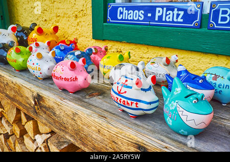 HALLSTATT, AUSTRIA - FEBRUARY 21, 2019: Traditional adobe piggy banks with colorful painted decorations are the nice souvenirs from Hallstatt, on Febr Stock Photo