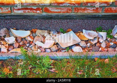 Decorative ceramic shards on a brick house wall. Stock Photo