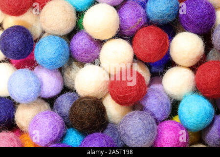 background of many felt balls for sale as christmas decorations Stock Photo