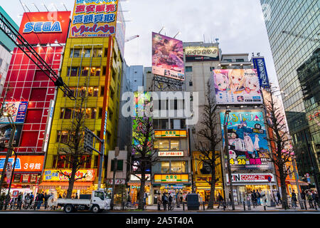 Tokyo, Akihabara. Chuo Dori, main shopping street. Across street view of pedestrians, buildings, Yoshinoya restaurant and the red Sega building. Stock Photo