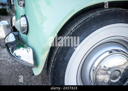 Whitewall tire mounted on restored 60s car. Closeup Stock Photo