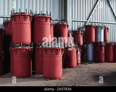 Red gland expansion joints for heating main on concrete floor. Heat and power concept. Stock Photo