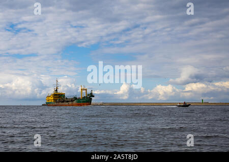 merchant ship entering the Baltic port in Poland Stock Photo