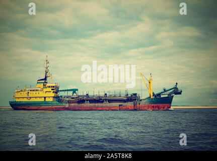 merchant ship entering the Baltic port in Poland Stock Photo