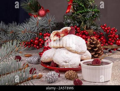 Traditional Christmas cookies biscuits snowballs covered icing sugar powder with almond nut stuffed with raspberry jam. Russian Tea Cakes, Mexican Wed Stock Photo