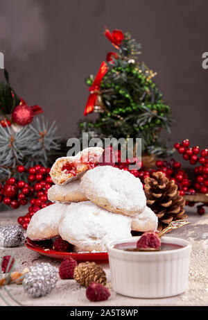 Traditional Christmas cookies biscuits snowballs covered icing sugar powder with almond nut stuffed with raspberry jam. Russian Tea Cakes, Mexican Wed Stock Photo