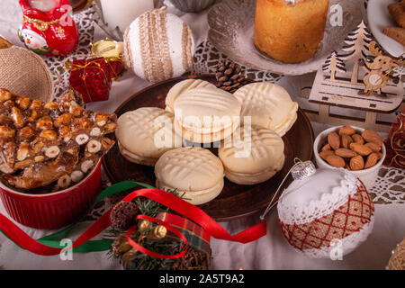 Traditional Christmas cookies biscuits Melting Moments and panforte on Christmas table. Christmas New Year ornament decorations. Stock Photo