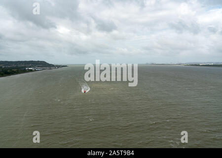 boat entering the Seine estuary from the English Channel in Le Havre and heading upriver towards Paris Stock Photo