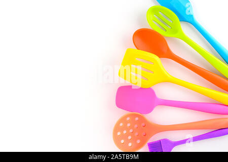 bright multi colored kitchen utensils on white background with copy space Stock Photo