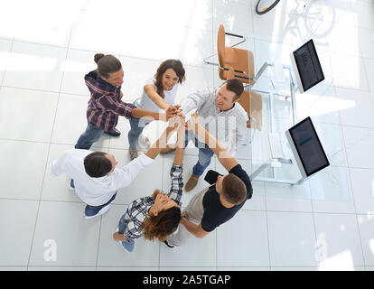 creative team giving each other a high five Stock Photo