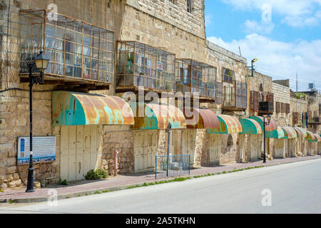 Empty shops and buildings on Shuhada Street, which is closed to Palestinians. Hebron (al-Khalil), West Bank, Palestine. Stock Photo