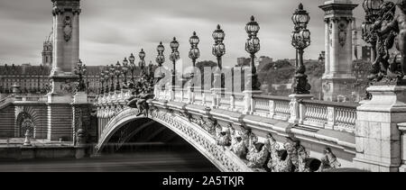 Close-up of Pont Alexandre III Bridge with its candelabras and lamp posts in Black & White. Paris, France, 7th Arrondissement Stock Photo