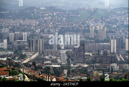 6th June 1993 During the Siege of Sarajevo: the view south from Hum Hill along Hamdije Čemerlića Street, known as Bratstva i Jedinstva (the street of 'Brotherhood and Unity') during the war. The street crosses Sniper Alley and the Miljacka River, into Bosnian-Serb-held Grbavica. At various points lorries and containers act as sniper barriers. Stock Photo