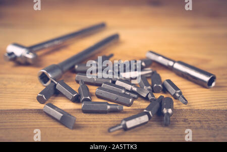 Set of bits for screwdriver. Metal bits for screwdriver. Nozzles and adapters for screwdrivers. Different size hex driver. Repair concept. Stock Photo