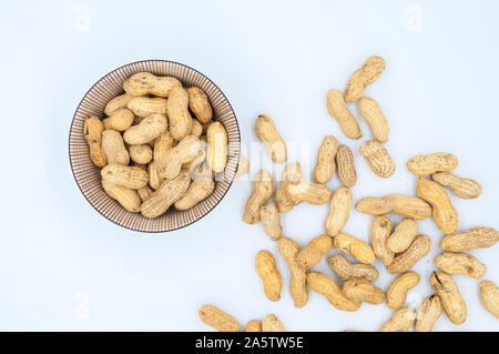 peanuts in shells in a bowl isolated on white background Stock Photo