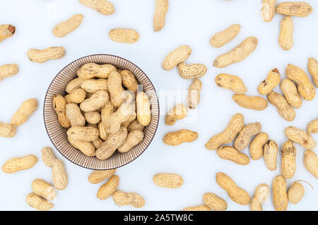 peanuts in shells in a bowl isolated on white background Stock Photo