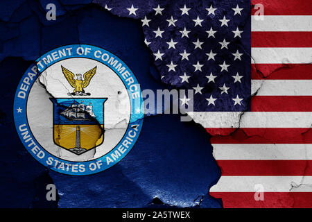 flags of Department of Commerce and USA painted on cracked wall Stock Photo