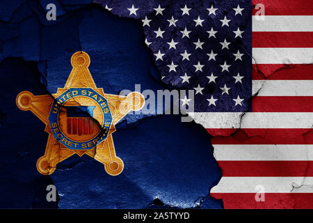 flags of United States Secret Service and USA painted on cracked wall Stock Photo