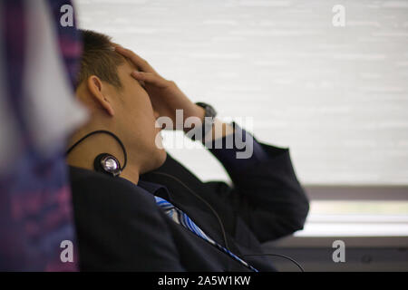 Young adult businessman sleeping on a train. Stock Photo