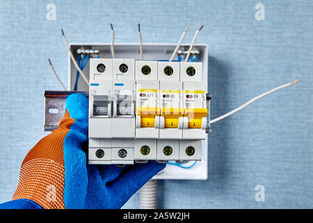 The electric installation work of engineering networks and systems. Electrical wiring service. Installing a consumer unit for home power system. An el Stock Photo