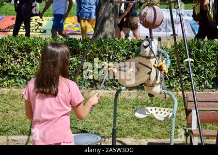 A child playing with a puppet at Ciutadella Park during La Merce 2019 in Barcelona, Spain Stock Photo