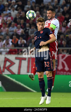 22 October 2019, Greece, Piräus: Soccer: Champions League, Olympiakos Piräus - Bayern Munich, Group stage, Group B, Matchday 3 at Georgios-Karaiskakis Stadium. Joshua Kimmich from Munich and Omar Elabdellaoui from Piraeus in action. Photo: Sven Hoppe/dpa Stock Photo