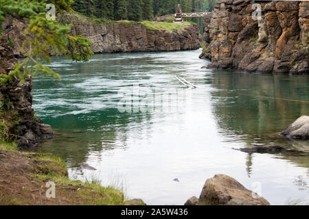 View of Miles Canyon, located just outside of Whitehorse, Yukon, Canada.  The Yukon River, part of the original gold rush route, flows through this. Stock Photo