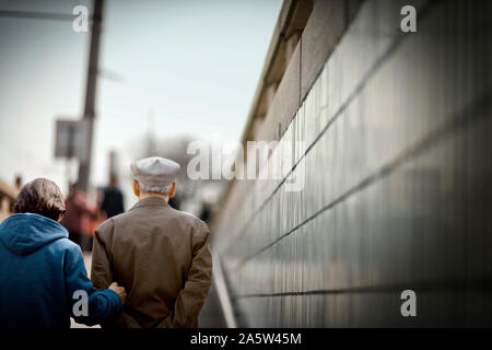 Man and woman walking up outdoors staircase Stock Photo