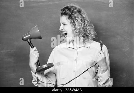 Teacher hold table lamp in hand chalkboard background. Knowledge day. Light up process of studying. Insight and idea. Educational idea. Woman work on bright shiny idea. Creativity and inspiration. Stock Photo