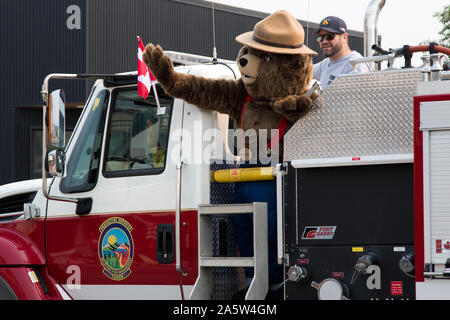 Smokey Bear riding in a fire truck taking part in the 2019 July 01st  Canada Day Parade held in Whitehorse, Yukon, Canada.  A national holiday. Stock Photo