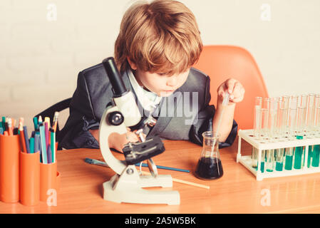 Life under microscope. science experiments with microscope in lab. school kid scientist studying science. Little boy is make science experiments. biology science. little boy at lesson. Back to school. Stock Photo