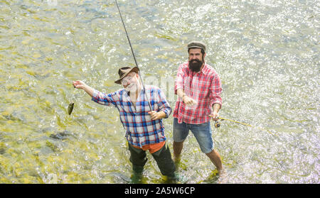 Bound Together In Love. two happy fisherman with fishing rods. summer  weekend. mature men fisher. father and son fishing. hobby and sport  activity. Trout bait. male friendship. family bonding — Stock Photo ©