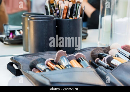 Close up various professional make up brushes lying in dark case Stock Photo