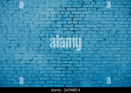 old red brick Brick wall painted with deep blue paint Stock Photo