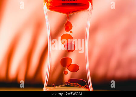 Red drops similar to blood falling in water. Stock Photo