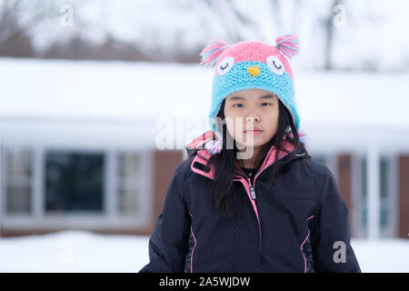 Winter portrait of little child girl wearing knitted hat Stock Photo