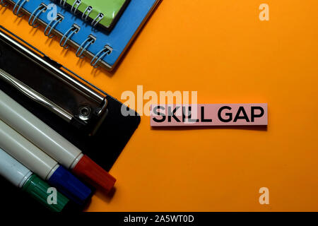 Skill Gap write on sticky notes. Isolated on orange table background Stock Photo