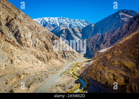 A singular roadway cutting through the Elqui Pisco Valley, Coquimbo, Chile. Stock Photo