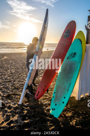 Unused surfboards are rested in the sandy beaches of La Serena, La Serena, Chile. Stock Photo