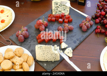 table assorted cheese and grapes Stock Photo