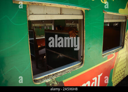 Passengers aboard a train in Yangon, Myanmar. Stock Photo